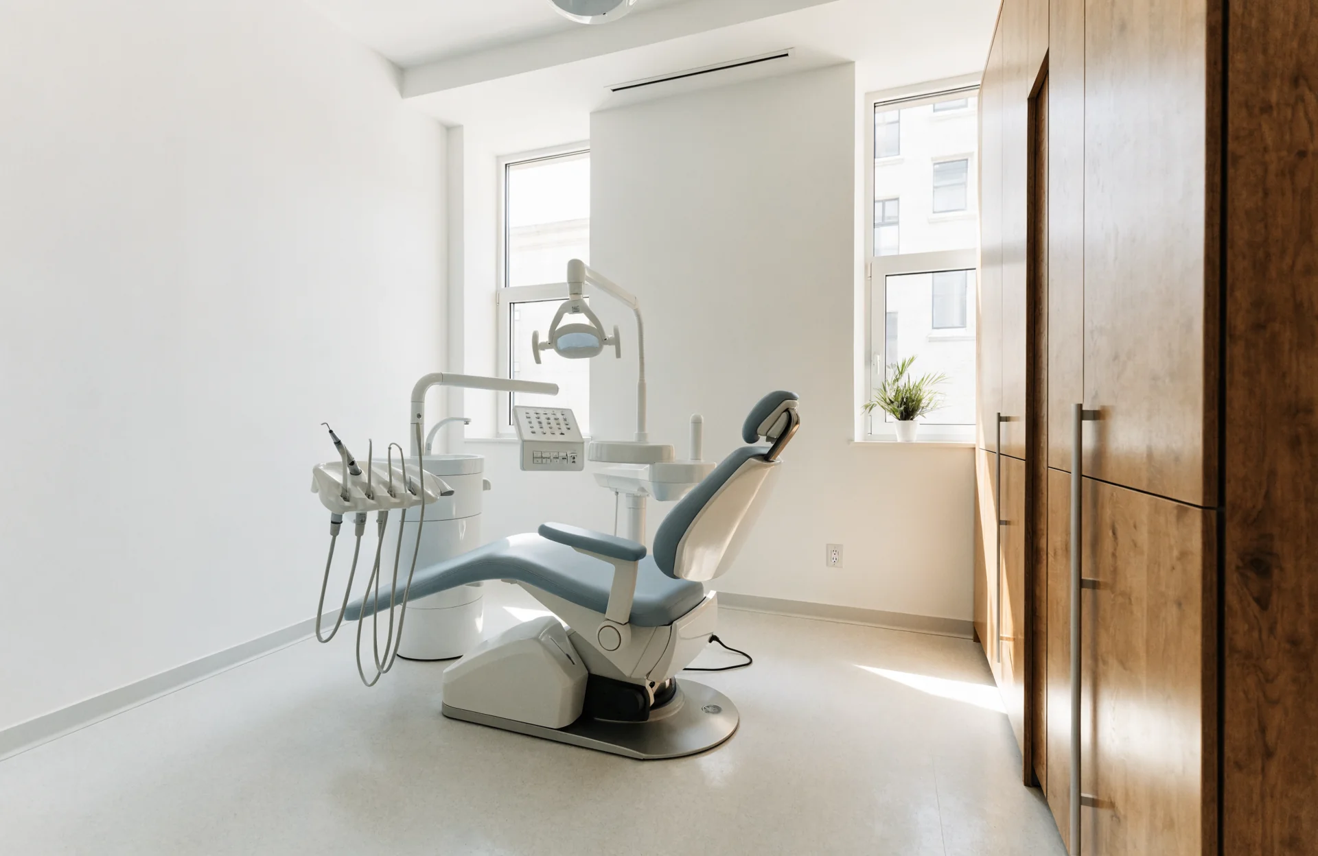 Illustrative calm dental consultation room with natural light and an unoccupied chair